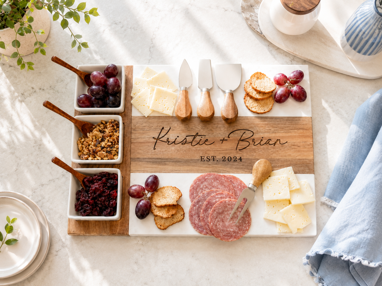 Wooden charcuterie board with meats, cheeses, and fruits on a marble surface.


